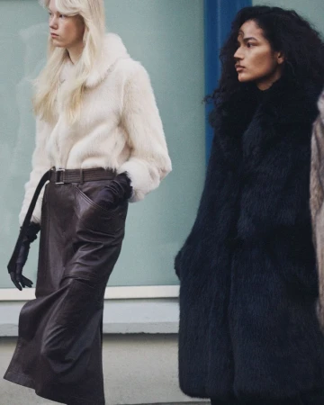 Two models wearing winter coats and leather gloves posing outdoors for Zara Pre-owned