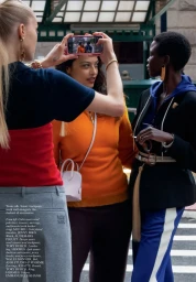 Models photographed by Barbara Probst for American Vogue, featuring a woman holding up a smartphone to take a photo of others.