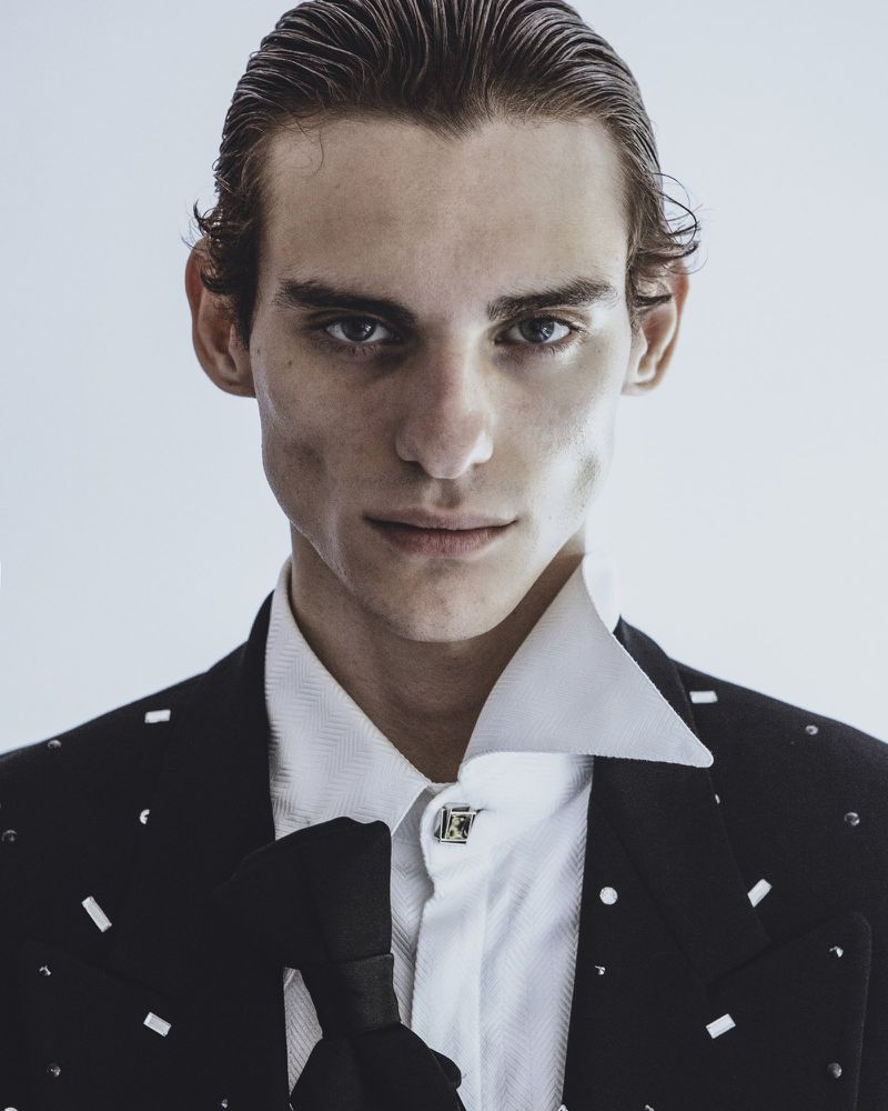 Close-up portrait of a male model in a black jacket and white shirt for Spaghetti Magazine