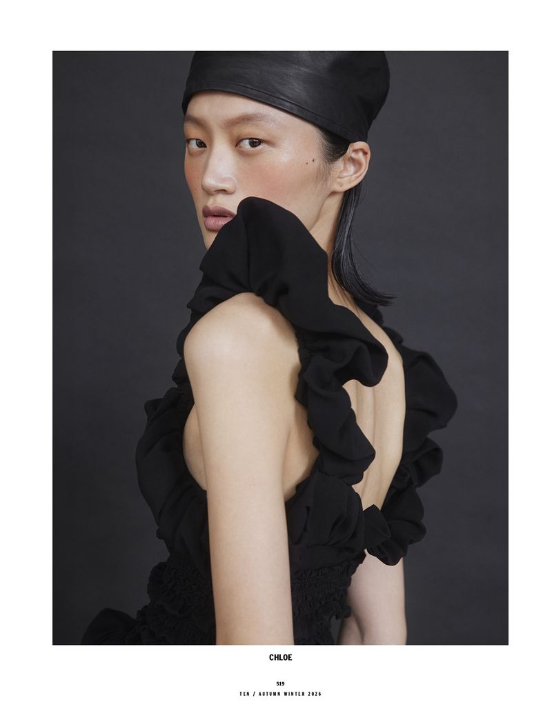 Model Yilan Hua wearing a black ruffled top and leather cap for 10 Magazine Day Shift editorial by Mark Pillai