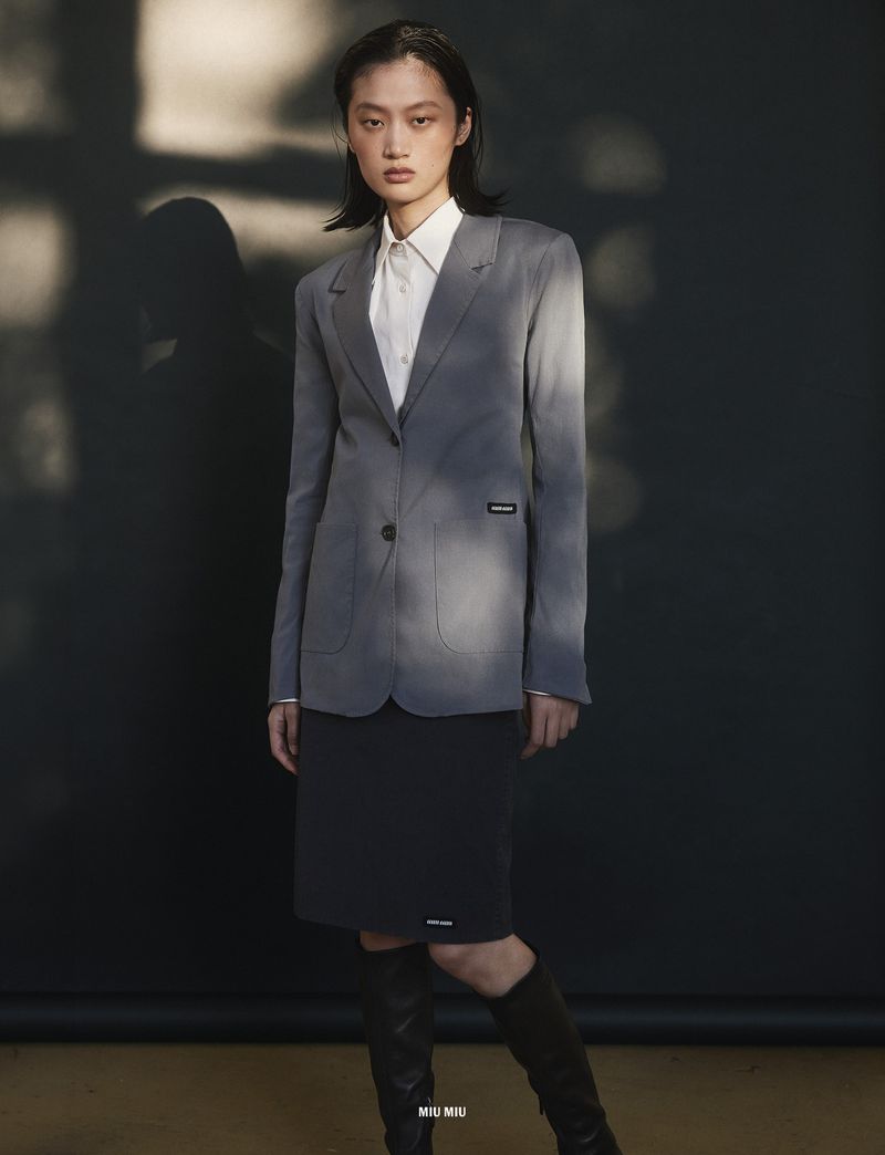 Yilan Hua in a grey blazer and skirt for 10 Magazine Day Shift editorial by Mark Pillai