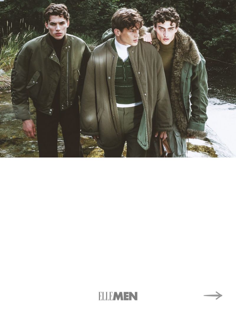 Three male models wearing green outerwear standing outdoors near a riverbank for an Elle Man Thailand editorial.