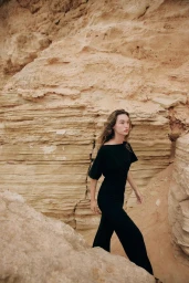 Model Jenn du Puy in a black outfit walking through a sandy canyon for Zara, photographed by Paolo Steve