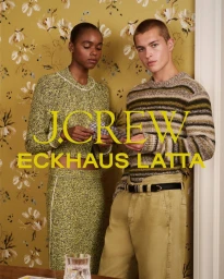 A Black woman and a white man posing together against an olive floral wallpaper background for a J.Crew and Eckhaus Latta campaign.