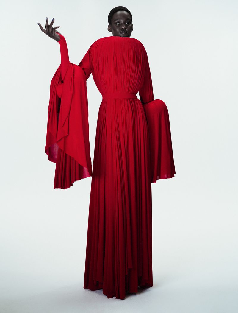 Model Caren Jepkemei wearing a sculptural pleated red gown in 10 Magazine's Jean Paul Gaultier Fantasia editorial.