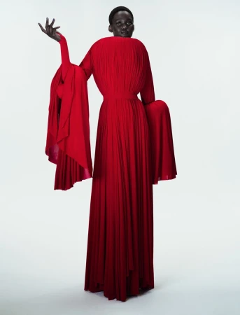 Model Caren Jepkemei wearing a sculptural pleated red gown in 10 Magazine's Jean Paul Gaultier Fantasia editorial.