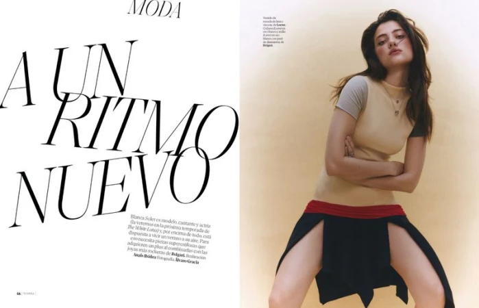 Model wearing a beige short-sleeve top and black skirt with dual front splits against a warm neutral backdrop