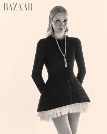 Leonie Hanne in a black textured dress with a layered white tulle hemline against a plain backdrop for Harper's Bazaar Vietnam