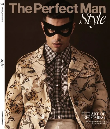 Model Denis Jovanovic wearing a floral print jacket, checkered shirt, and black mask for The Perfect Man Magazine.