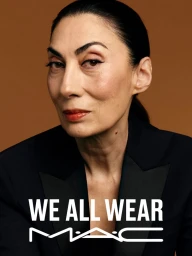 Portrait of a mature woman wearing a black blazer with text overlay against a warm brown background