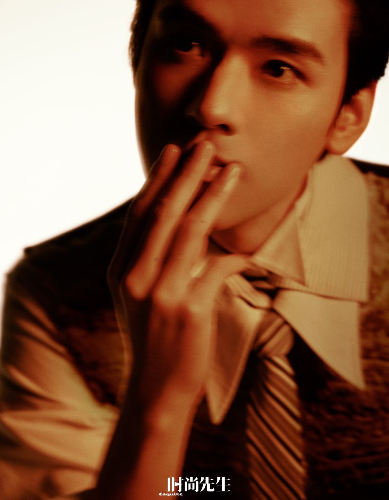 Close up portrait of actor Gong Jun wearing a collared shirt and tie with warm lighting for Esquire China editorial