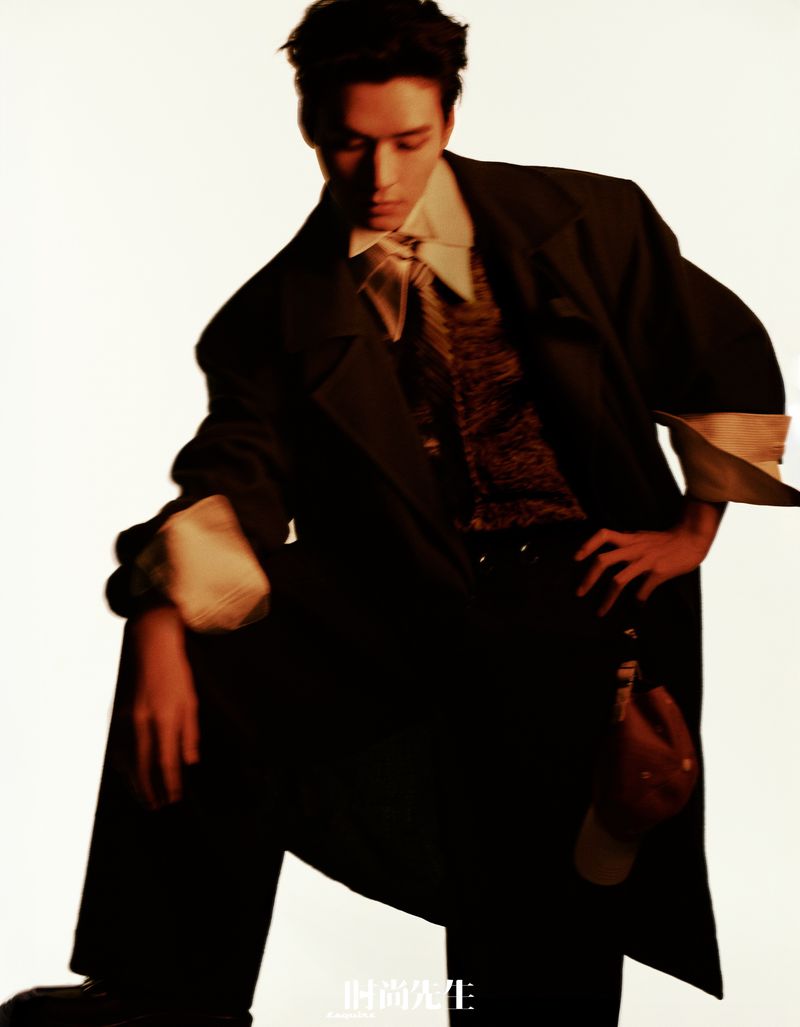 Gong Jun wearing a dark coat and collared shirt against a pale backdrop for Esquire China.