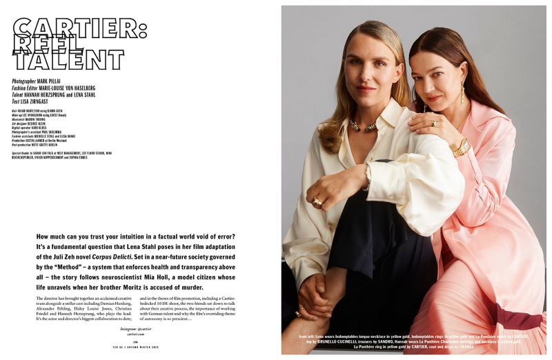Two women posing together for an editorial portrait, wearing fine jewelry and styled clothing against a neutral studio backdrop.