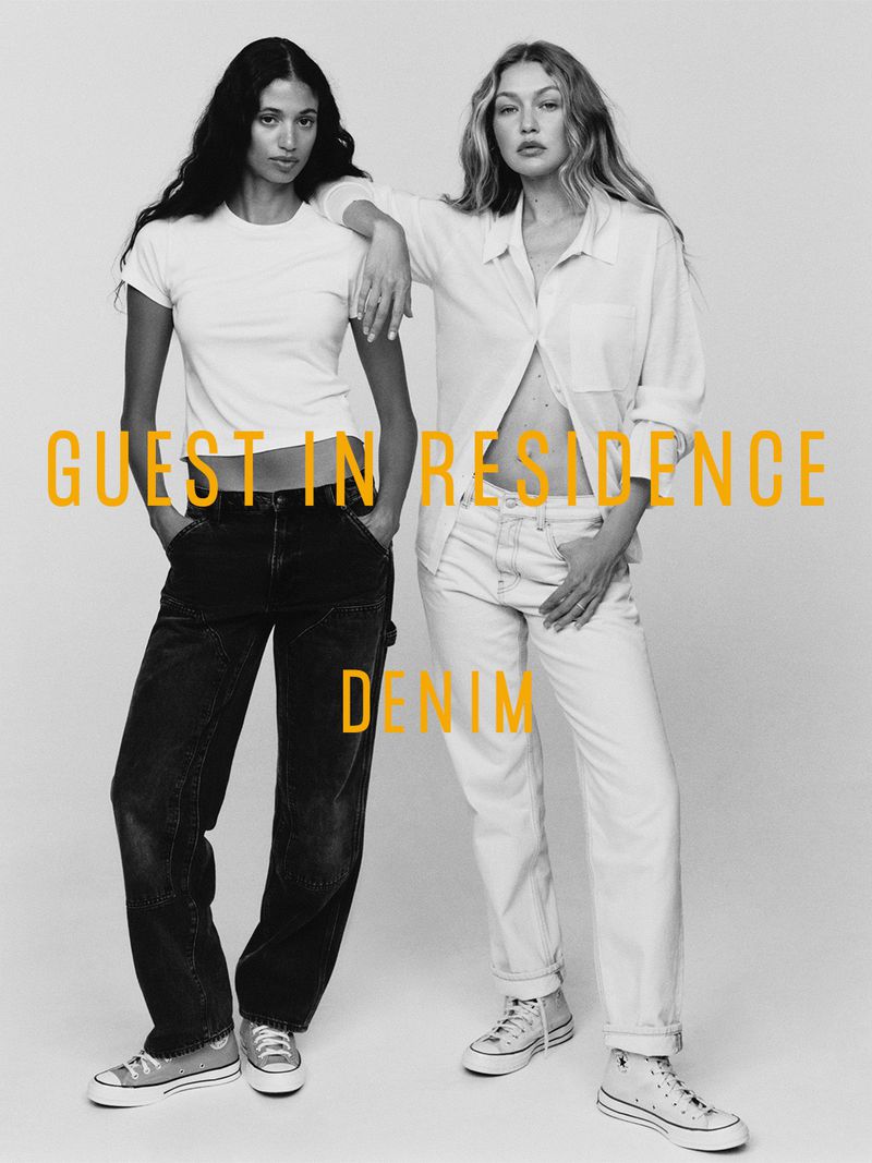 Gigi Hadid and Malika El Maslouhi wearing white shirts and denim for the Guest In Residence Denim campaign against a neutral backdrop.