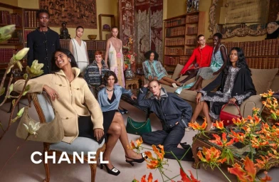 Group of models in a wood-paneled library wearing Chanel F/W 2026 collection apparel and accessories.