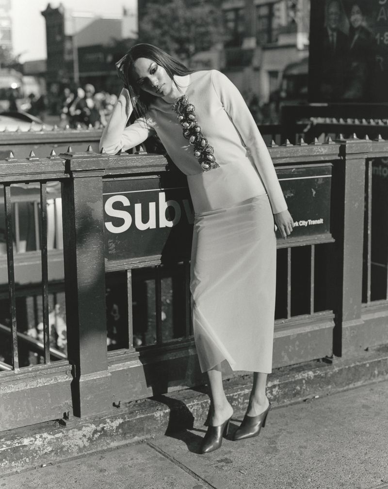 Model Ajah Angau Jok leaning against a subway entrance railing for 10 Magazine editorial project Harlem Renaissance