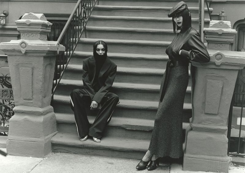 Two black female models posing on brownstone building exterior steps for 10 Magazine Harlem Renaissance editorial.