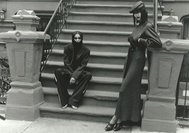 Two black female models posing on brownstone building exterior steps for 10 Magazine Harlem Renaissance editorial.