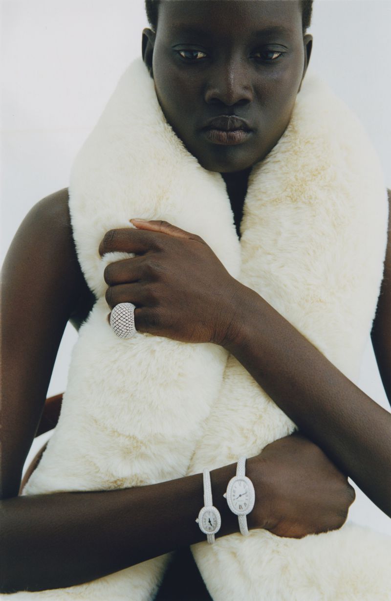 Black woman wearing a large white faux fur scarf and jewelry for My Magazine
