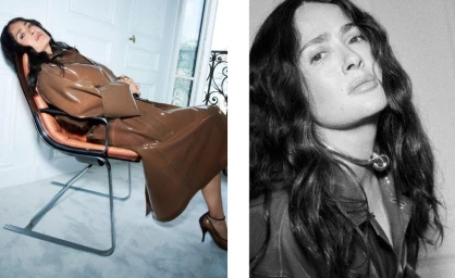 Salma Hayek seated in an orange leather chair wearing a glossy brown coat for The Cut photographed by Julia Noni.