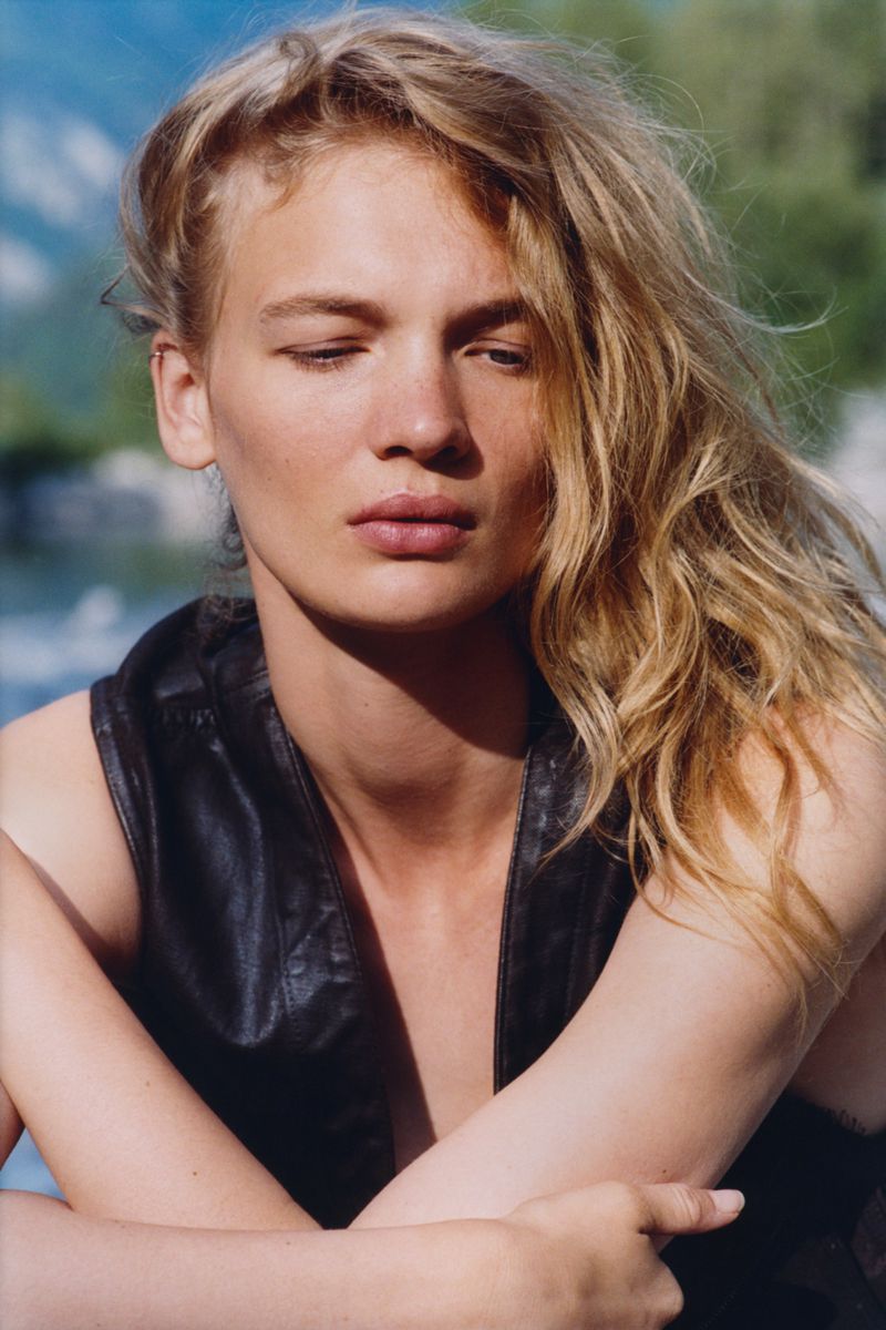 Model Caitlin Soetendal wearing a dark leather sleeveless top outdoors for a Pop Magazine editorial project shot by Laura Jane Coulson.