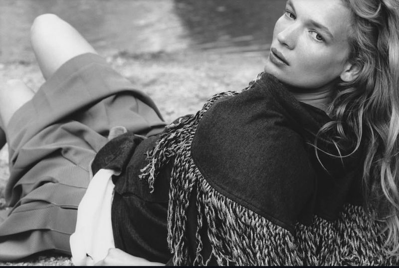 Black and white editorial portrait of model Caitlin Soetendal lying outdoors near water for Pop Magazine, photographed by Laura Jane Coulson.