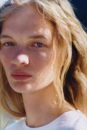 Close-up portrait of model Caitlin Soetendal with blonde hair and natural makeup for Pop Magazine.