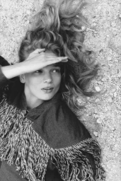 Model Caitlin Soetendal lying down with hand shielding eyes in editorial portrait by Laura Jane Coulson for Pop Magazine
