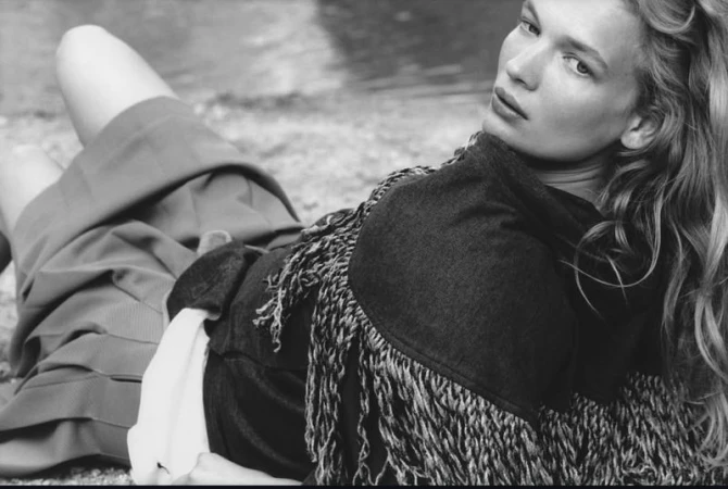 Black and white editorial portrait of model Caitlin Soetendal lying outdoors near water for Pop Magazine, photographed by Laura Jane Coulson.
