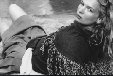 Black and white editorial portrait of model Caitlin Soetendal lying outdoors near water for Pop Magazine, photographed by Laura Jane Coulson.