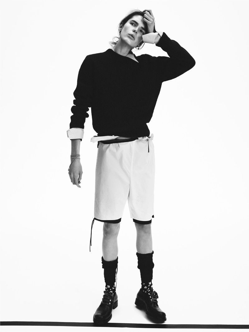 Model in black sweater and white shorts posing against a white background for D Repubblica Youngblood editorial.