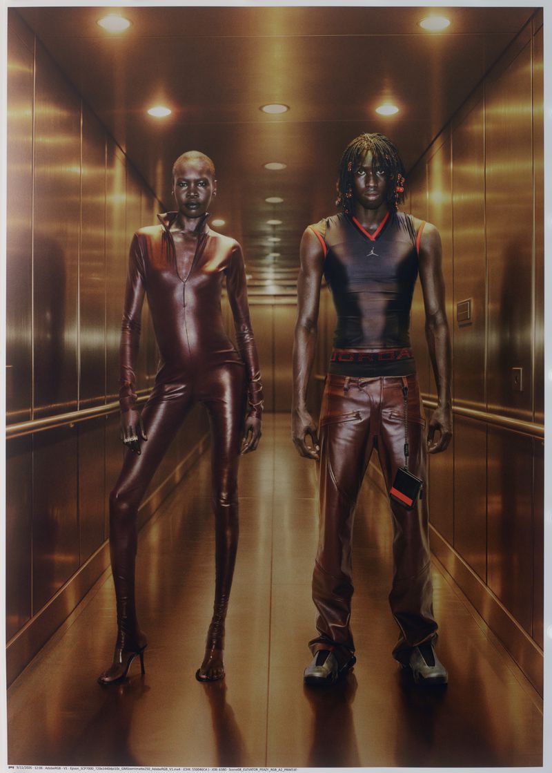 Two models standing in a warm metallic elevator interior for Mowalola x Jordan 2026 campaign.