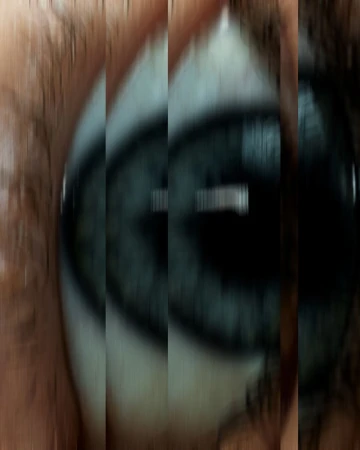 Macro shot of a human eye with blue iris and visible skin texture around the eye. Focus on the details of the eye.