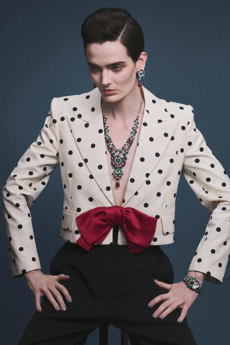 Model wearing a polka dot blazer and ruby necklace against a solid background for L'Officiel Chile