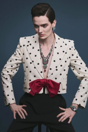 Model wearing a polka dot blazer and ruby necklace against a solid background for L'Officiel Chile