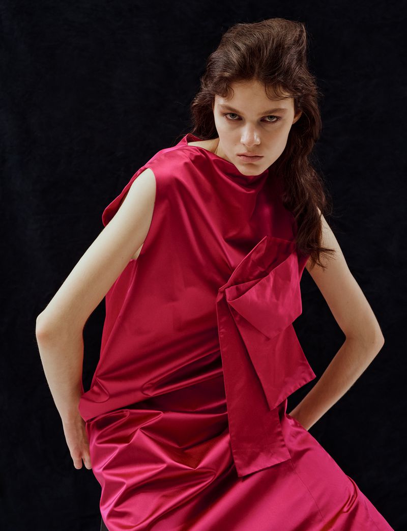 Model Hanna Leszek in a magenta silk dress posing against a dark background for 10 Magazine USA