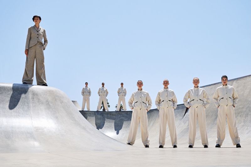 Group of models in matching cream outfits posed across a concrete skate park under a clear sky for Vogue Portugal editorial We are the pattern