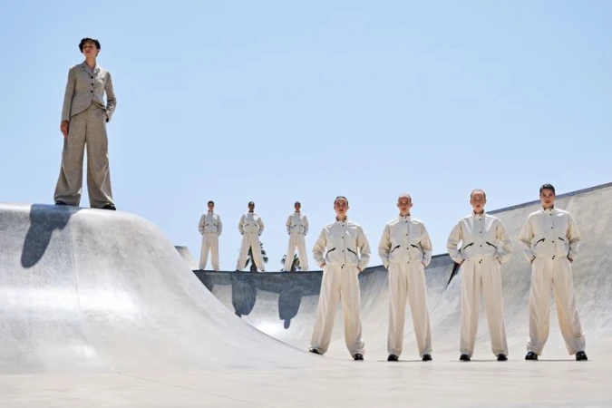 Group of models in matching cream outfits posed across a concrete skate park under a clear sky for Vogue Portugal editorial We are the pattern
