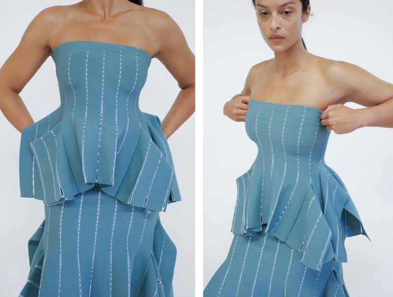 Model wearing a structured blue strapless peplum top and matching skirt against a plain white background for Proenza Schouler