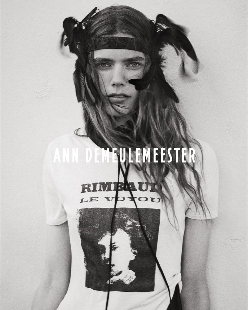 Model wearing graphic t-shirt and feather headband for Ann Demeulemeester campaign