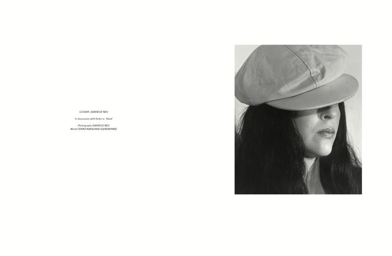 Black and white portrait of a woman wearing a newsboy cap pulled low, photographed by Danielle Neu for Pop Magazine.