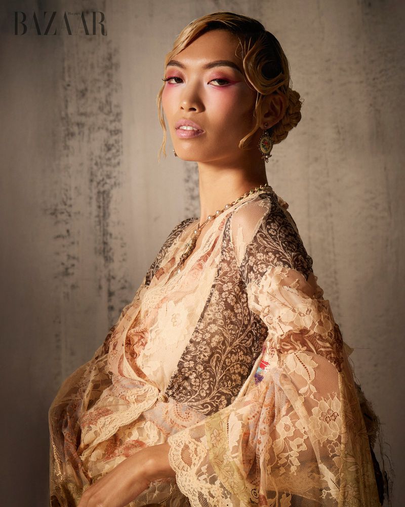 Model Lauren Nguyen wearing a patterned lace garment with styled vintage hair for Harper's Bazaar Vietnam, photographed by Tom Marvel.