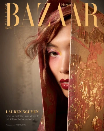 Close-up portrait of model Lauren Nguyen partially draped in a gold and pink patterned fabric for Harper's Bazaar Vietnam.