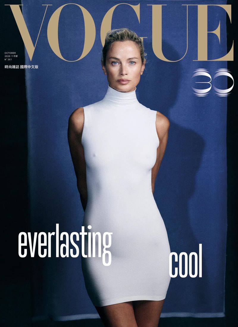 Model Carolyn Murphy wearing a white sleeveless turtleneck dress against a textured dark blue backdrop for Vogue Taiwan October 2026 cover.