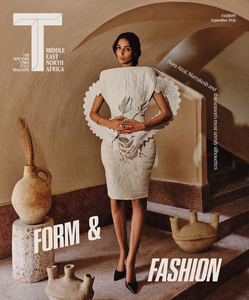 Model Nora Attal in a structured white dress standing inside a vaulted interior with ceramic vases for T Magazine MENA