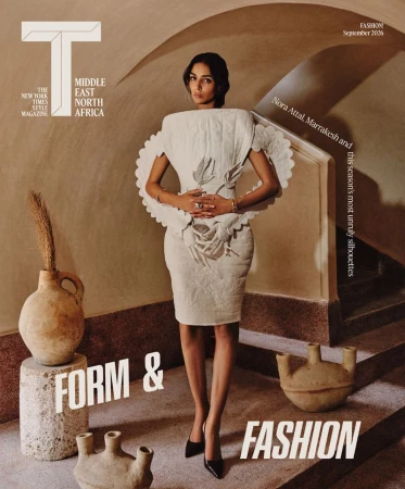 Model Nora Attal in a structured white dress standing inside a vaulted interior with ceramic vases for T Magazine MENA