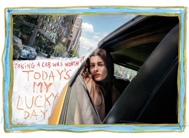Woman looking out from a car window next to handwritten red text on a painted blue border background