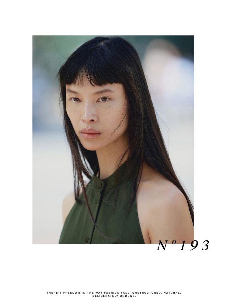 Model Diane Chiu in an olive green sleeveless top looking at the camera in an editorial layout for Massimo Dutti.