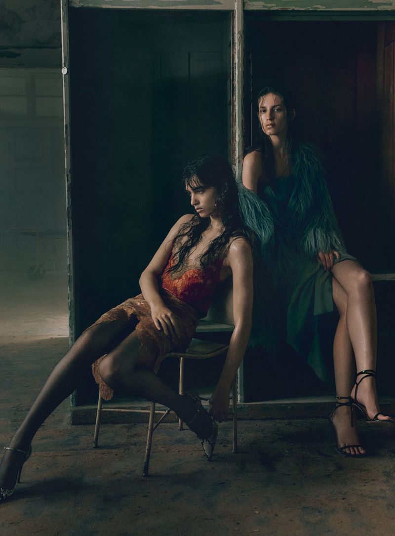 Two female models posing in moody interior lighting for V Magazine editorial Feel the heat