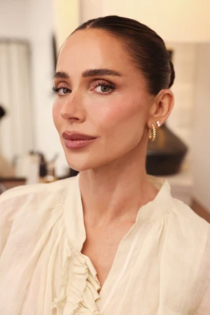 Close-up portrait of Mary Phillips wearing a cream blouse and gold hoop earrings for La Mer The Concentrate Confessions project